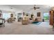 Spacious living room with beige carpeting, a seating area, and dining area at 6256 Sandpipers Dr, Lakeland, FL 33809