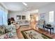 Spacious living room with hardwood floors, comfortable seating, and large windows at 6461 Hollyberry Ne Ln, Winter Haven, FL 33881