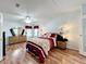 Spacious bedroom with wood flooring and a ceiling fan at 6461 Hollyberry Ne Ln, Winter Haven, FL 33881