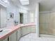 Bathroom boasts double sinks, a shower, and updated vanity at 6461 Hollyberry Ne Ln, Winter Haven, FL 33881