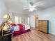 Bright bedroom with wood floors, ceiling fan and walk-in closet at 6461 Hollyberry Ne Ln, Winter Haven, FL 33881