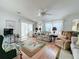 Bright and airy living room featuring hardwood floors and floral patterned furniture at 6461 Hollyberry Ne Ln, Winter Haven, FL 33881
