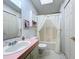 Simple bathroom with shower/tub combo and pink vanity at 6461 Hollyberry Ne Ln, Winter Haven, FL 33881