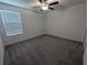 Spacious bedroom with grey carpet and ceiling fan at 2739 Red Egret Dr, Bartow, FL 33830