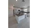 Modern kitchen with a large granite island and white cabinets at 2739 Red Egret Dr, Bartow, FL 33830