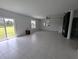 Bright and spacious living room with tile floors and sliding glass doors leading to backyard at 2739 Red Egret Dr, Bartow, FL 33830