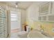 Clean bathroom with yellow tiled walls and updated vanity at 285 Lemon St, Mulberry, FL 33860