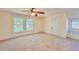 Large bedroom featuring a ceiling fan and multiple windows at 285 Lemon St, Mulberry, FL 33860
