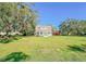 Front view of a charming white farmhouse on a spacious lot at 285 Lemon St, Mulberry, FL 33860