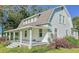 Two-story white house with a gambrel roof and large front porch at 285 Lemon St, Mulberry, FL 33860