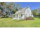 White farmhouse with a wrap-around porch and large yard at 285 Lemon St, Mulberry, FL 33860