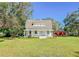 Farmhouse exterior with a large yard and mature trees at 285 Lemon St, Mulberry, FL 33860