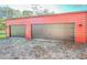 Detached three-car garage with brown doors at 285 Lemon St, Mulberry, FL 33860