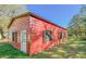 Red metal garage with white door and windows at 285 Lemon St, Mulberry, FL 33860