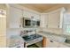 Stainless steel appliances and granite countertops in this updated kitchen at 285 Lemon St, Mulberry, FL 33860