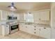 Updated kitchen featuring white shaker cabinets and stainless steel appliances at 285 Lemon St, Mulberry, FL 33860