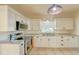 Modern kitchen with white cabinets, stainless steel appliances, and granite countertops at 285 Lemon St, Mulberry, FL 33860