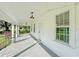 Long front porch with white columns and wooden flooring at 285 Lemon St, Mulberry, FL 33860