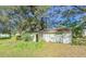 White storage shed with double doors and a trellis at 285 Lemon St, Mulberry, FL 33860