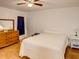 Bedroom with ceiling fan and wooden dresser at 4197 Cannes Ave, Lake Wales, FL 33859