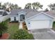 One-story home with attached garage and landscaped yard at 4197 Cannes Ave, Lake Wales, FL 33859