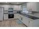 Kitchen features white cabinets, granite counters, and modern appliances at 4197 Cannes Ave, Lake Wales, FL 33859