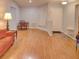 Living area with hardwood floors, orange couch, and entryway at 4197 Cannes Ave, Lake Wales, FL 33859