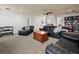 Spacious bonus room with leather couches, a TV, and built-in shelving at 4511 Micanope Crescent Dr, Lakeland, FL 33811