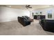 Multipurpose bonus room with two couches, a large TV, and built-in shelves at 4511 Micanope Crescent Dr, Lakeland, FL 33811