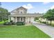 Two-story house with stone accents, covered porch, and landscaped yard at 4511 Micanope Crescent Dr, Lakeland, FL 33811