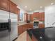 Updated kitchen with wood cabinets, granite counters, and stainless steel appliances at 4511 Micanope Crescent Dr, Lakeland, FL 33811