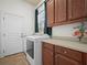 Laundry room with washer, dryer, and wood cabinets at 4511 Micanope Crescent Dr, Lakeland, FL 33811