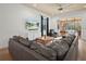 Spacious living room with sectional sofa, large TV, and access to the pool area at 4511 Micanope Crescent Dr, Lakeland, FL 33811