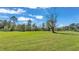 Spacious backyard with mature trees and grassy area at 4616 Musket Dr, Lakeland, FL 33810