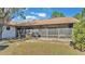 Home exterior showcasing a screened patio and grassy backyard at 4616 Musket Dr, Lakeland, FL 33810