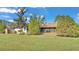 Backyard with screened porch, grassy area, and storage shed at 4616 Musket Dr, Lakeland, FL 33810