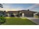 House exterior at dusk with a two-car garage and landscaping at 4616 Musket Dr, Lakeland, FL 33810