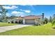 House exterior with a brown garage door and grassy yard at 4616 Musket Dr, Lakeland, FL 33810