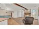Spacious living room with a brick fireplace, wood beams, and a ceiling fan at 4616 Musket Dr, Lakeland, FL 33810