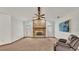 Living room boasts a brick fireplace, ceiling fan and large window at 4616 Musket Dr, Lakeland, FL 33810