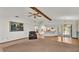 Open living room with a fireplace, kitchen views, and access to the patio at 4616 Musket Dr, Lakeland, FL 33810