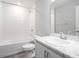 Clean bathroom with bathtub, toilet and vanity with marble countertop at 5108 Sylas Jax Ave, Winter Haven, FL 33884