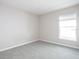 Bright bedroom with gray walls and carpeted floors at 5108 Sylas Jax Ave, Winter Haven, FL 33884