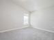 Bright bedroom with grey carpet and a window at 5108 Sylas Jax Ave, Winter Haven, FL 33884