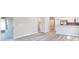 Spacious living area with wood-look flooring and access to a patio at 5108 Sylas Jax Ave, Winter Haven, FL 33884