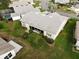 Aerial view of home showcasing backyard, landscaping, and screened patio at 6064 Condor Dr, Lakeland, FL 33809