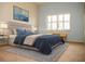 Virtually staged bedroom with a plush bed and window seating at 6064 Condor Dr, Lakeland, FL 33809
