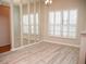 Dining room with light walls, wood floors, and large windows at 6064 Condor Dr, Lakeland, FL 33809