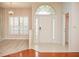Bright entryway with hardwood floors and arched entry door at 6064 Condor Dr, Lakeland, FL 33809