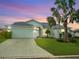 Charming house exterior with a palm tree and driveway at 6064 Condor Dr, Lakeland, FL 33809